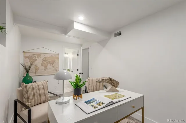 a view of a patio with a table and chairs under an umbrella
