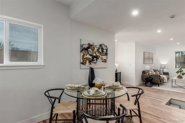 a view of a dining room with furniture and wooden floor