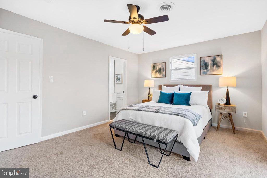 424 53rd Street Southeast Washington, DC 20019 - Photo 21 of 40 a spacious bedroom with a bed and a chandelier