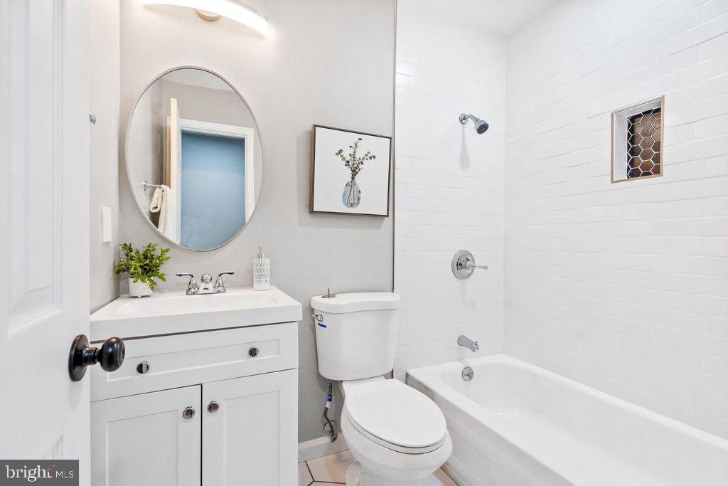 424 53rd Street Southeast Washington, DC 20019 - Photo 29 of 40 a bathroom with a toilet a sink a mirror and a bathtub