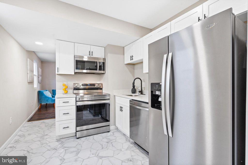 424 53rd Street Southeast Washington, DC 20019 - Photo 9 of 40 a kitchen with stainless steel appliances a refrigerator sink and microwave