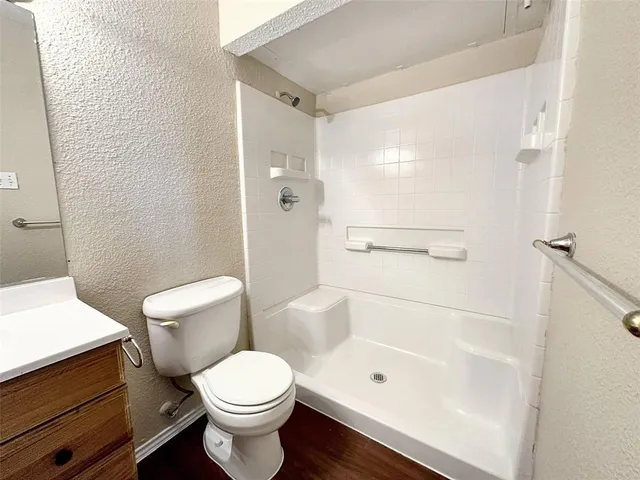 a spacious bedroom with a bed and a chandelier