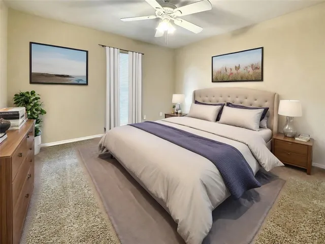 an empty room with a ceiling fan and window