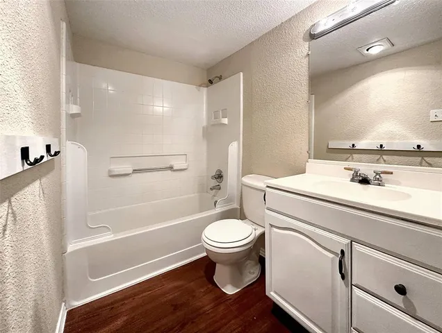 a spacious bedroom with a bed and a chandelier