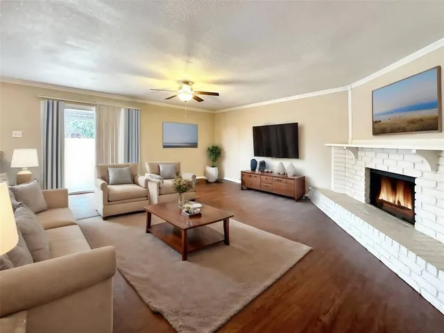 an empty room with wooden floor and fireplace
