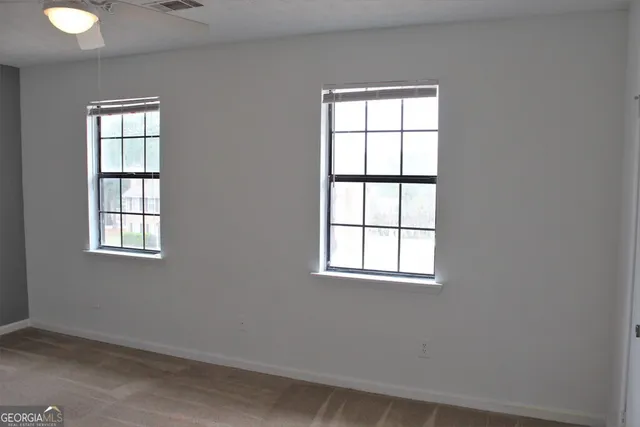 a view of an empty room with windows