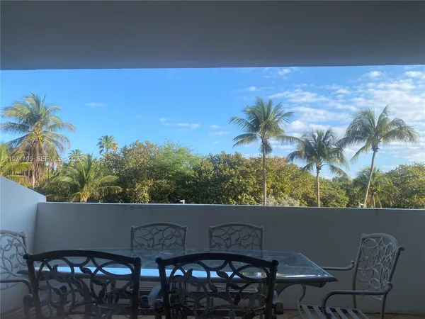 a view of a pathway both side of building with yard