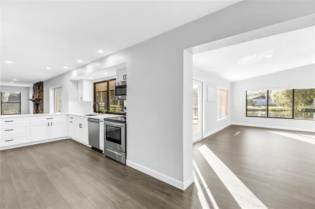 a view of a dining room with furniture wooden floor and chandelier