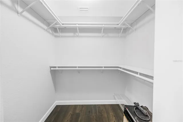 a white kitchen with a sink and cabinets