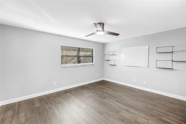 a bathroom with a granite countertop sink a toilet a mirror and shower