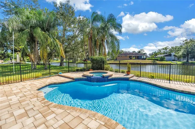 a view of a house with swimming pool and sitting area