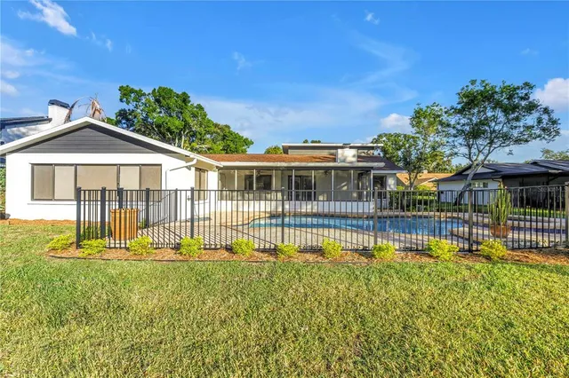 a view of a swimming pool with an outdoor space and seating area