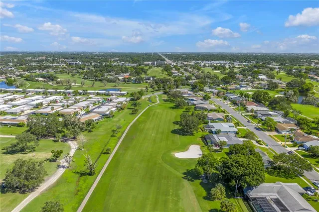 an aerial view of a residential houses with outdoor space and a garden