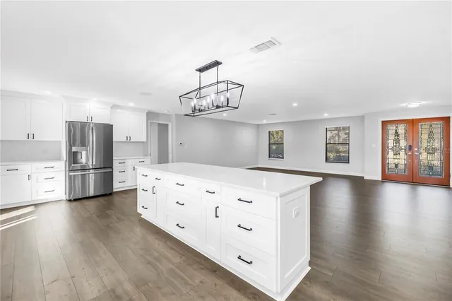 a kitchen with stainless steel appliances a refrigerator sink and cabinets