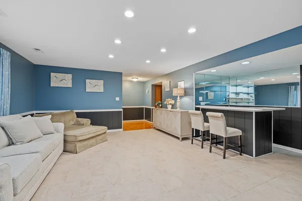 a living room with furniture and kitchen view