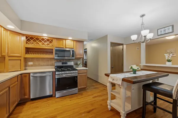 a kitchen with kitchen island a stove a sink and a refrigerator