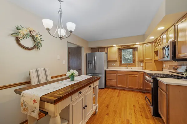 a kitchen that has a lot of cabinets a sink and appliances in it