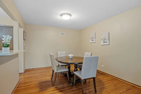a view of a dining room with furniture and wooden floor