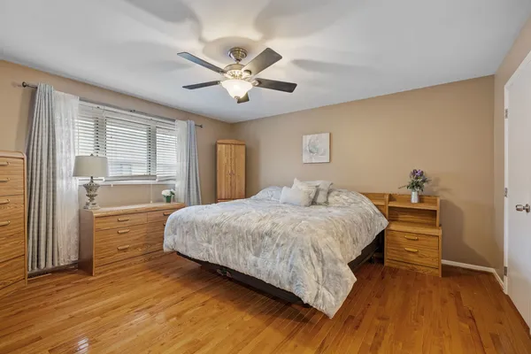 a spacious bedroom with a bed and a chandelier