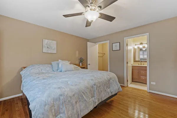 a spacious bedroom with a bed and a chandelier