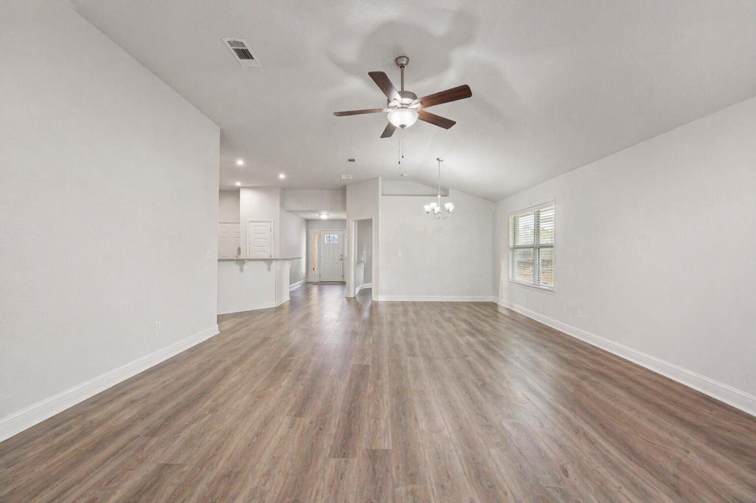 109 Ridgeway Circle Crestview, FL 32536 - Photo 5 of 18 a view of empty room with wooden floor and fan