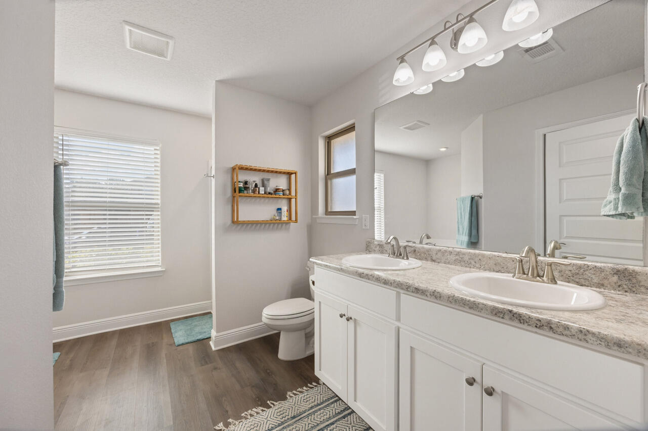 109 Ridgeway Circle Crestview, FL 32536 - Photo 8 of 18 a bathroom with a granite countertop toilet a sink and a mirror