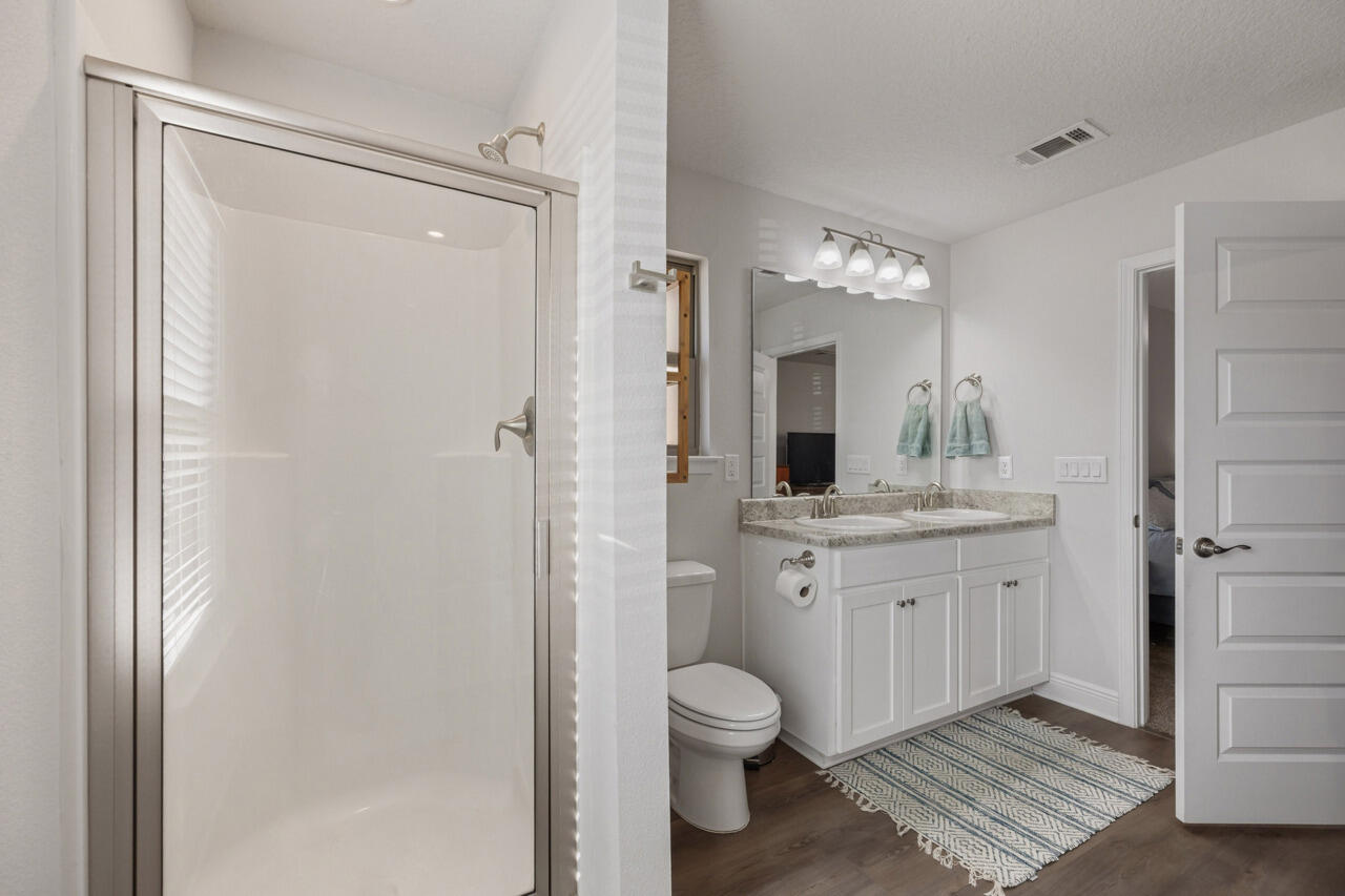 109 Ridgeway Circle Crestview, FL 32536 - Photo 9 of 18 a bathroom with a granite countertop sink toilet and shower