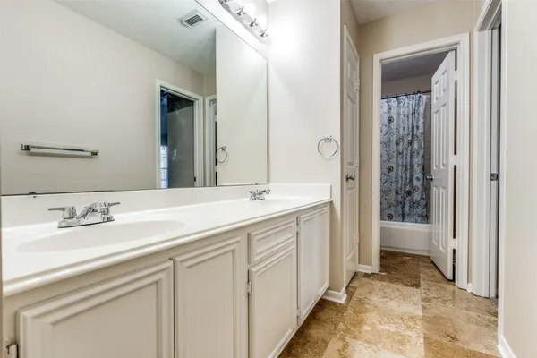 a spacious bathroom with a shower and a sink
