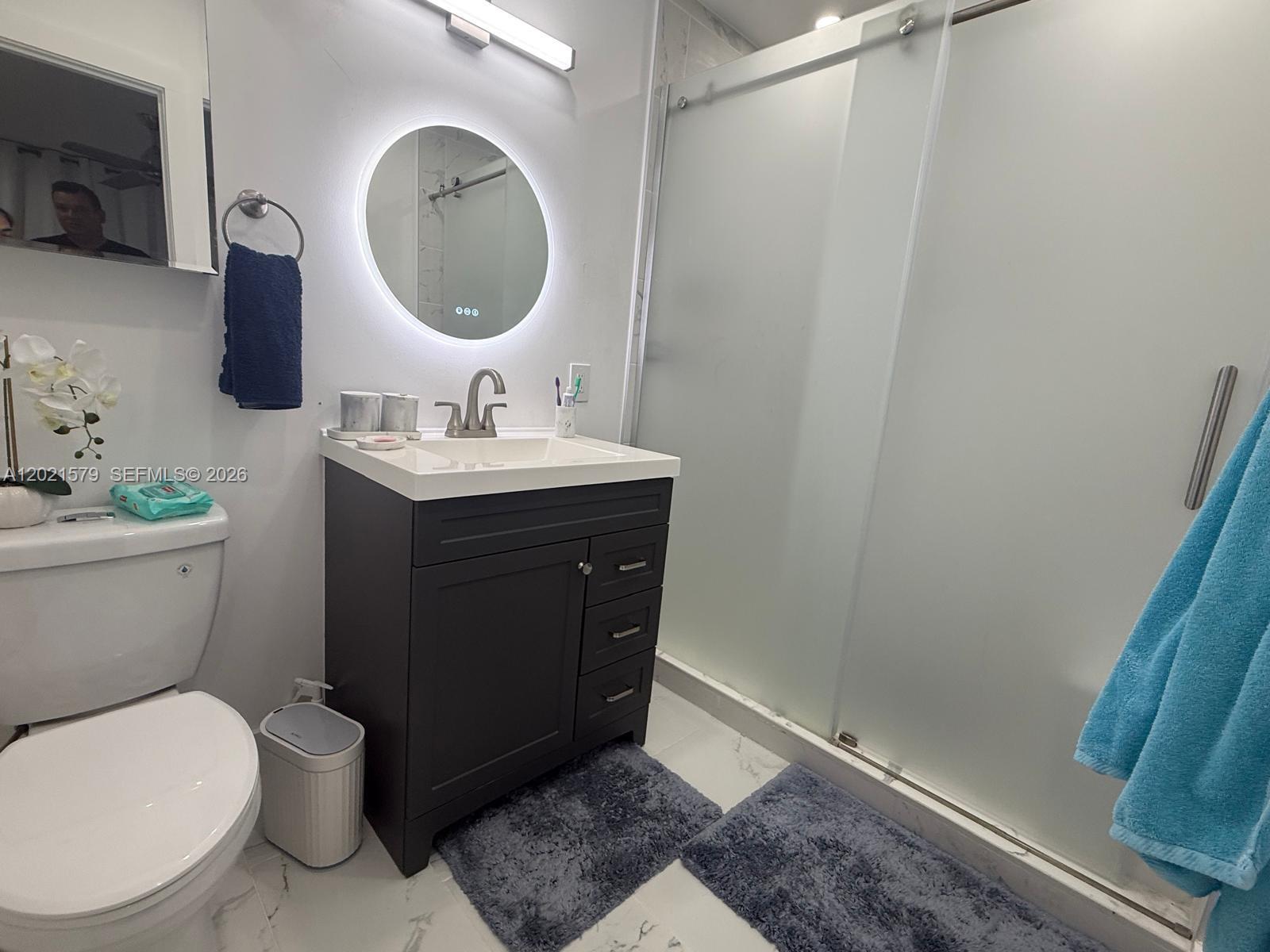 22445 Southwest 264th Street Homestead, FL 33031 - Photo 6 of 12 a bathroom with a toilet a sink and mirror