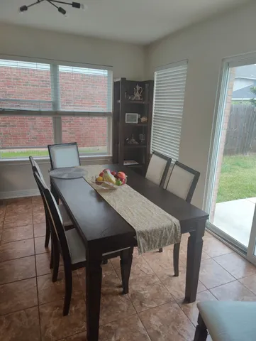 a view of a dining room with furniture and window