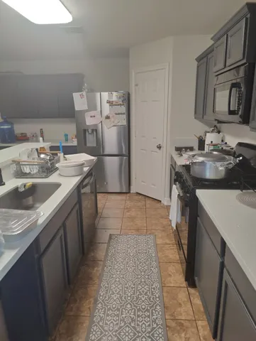 a kitchen with a sink stove and refrigerator