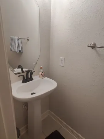 a bathroom with a sink and mirror