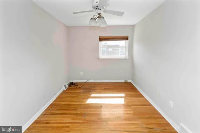 a view of a room with wooden floor and chandelier