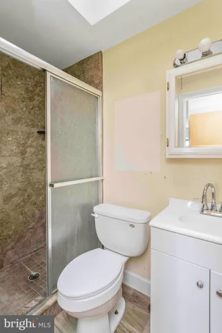 a bathroom with a toilet a sink and shower
