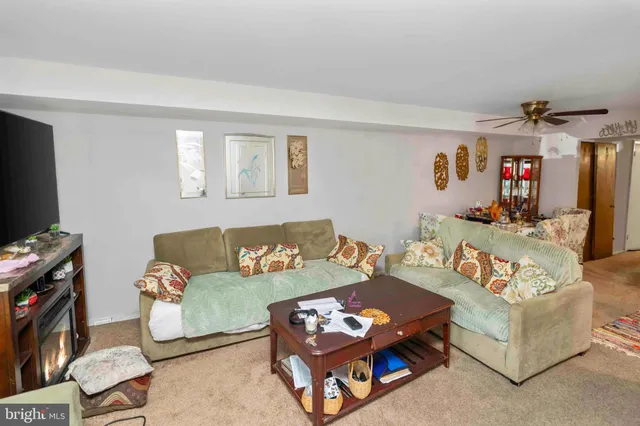 a living room with furniture a rug and a flat screen tv