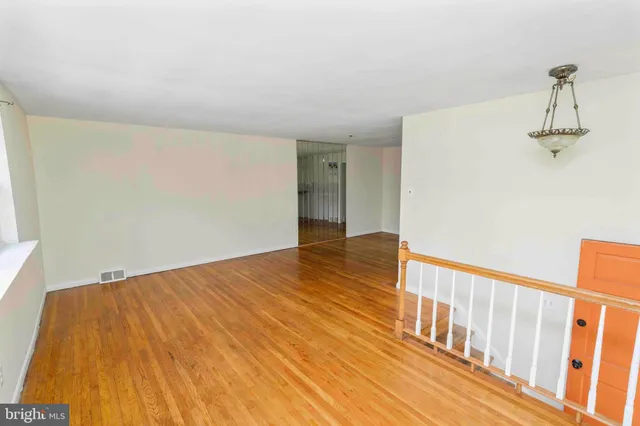 a view of a room with wooden floor and stairs