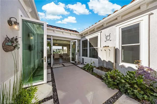 a view of a house with swimming pool and furniture