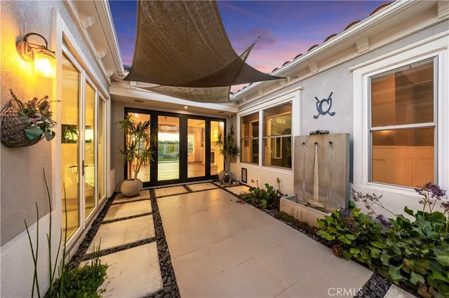 a view of a house with backyard sitting area and garden