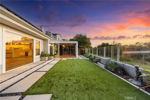 a view of a house with backyard and porch