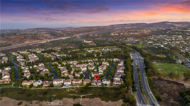 a view of an empty room with a window and fireplace