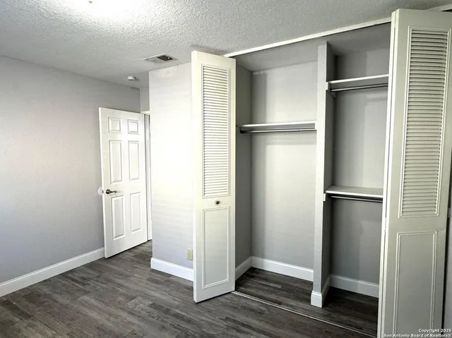 a view of closet area with wooden floor