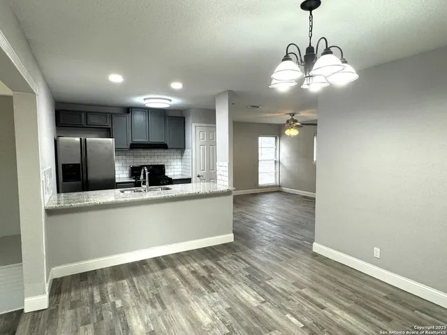 a view of a kitchen with a sink and stainless steel appliances