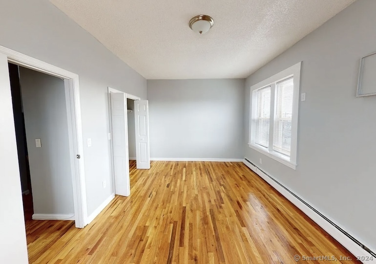 335 Wells Street, Unit 18 Bridgeport, CT 06606 - Photo 2 of 4 a view of empty room with wooden floor