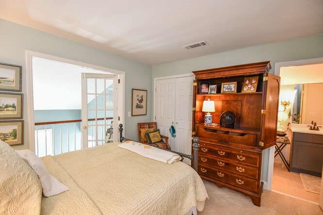 2901 Club Place Gainesville, GA 30506 - Photo 37 of 57 a bedroom with a bed and a flat tv screen on dresser in it
