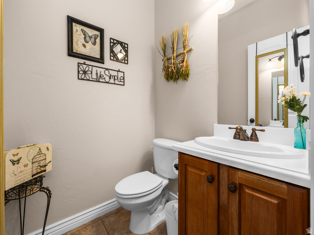 255 East 1200 North Mapleton, UT 84664 - Photo 22 of 37 Powder room featuring a single vanity with wood-finish cabinetry, a white countertop, and an oval sink