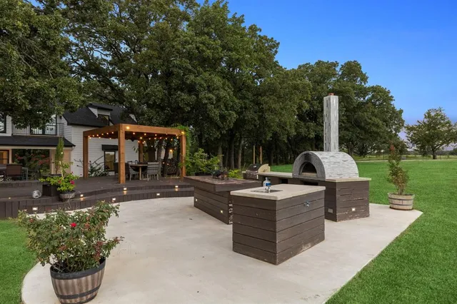 a view of a patio with couches and a fire pit