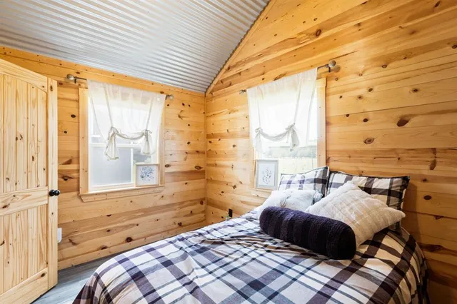 a bedroom with a bed and a window