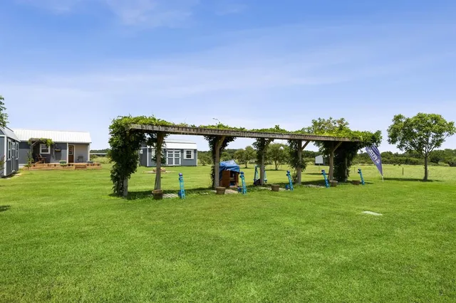 a view of a house with a backyard
