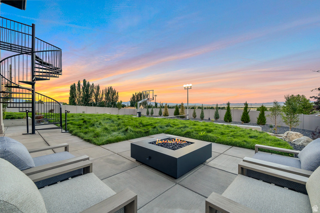 2145 North Main Street Centerville, UT 84014 - Photo 9 of 53 Fenced backyard with stairs and an outdoor living space with a fire pit