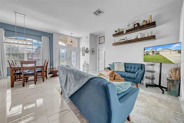 a kitchen with kitchen island granite countertop a stove top oven a sink a counter top space and cabinets